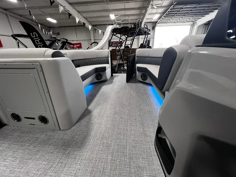 Slide: The Image of 2024 Harris Sunliner 230 pontoon boat interior with LED lighting and plush seating. - 19