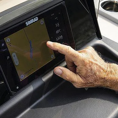 Slide: The Image of Close-up of a hand using a Simrad navigation system on a 2024 Harris Sunliner 230 boat. - 22