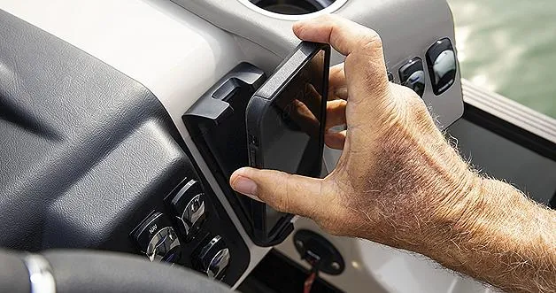 Slide: The Image of Hand adjusting control panel on 2024 Harris Sunliner 230 boat. - 24