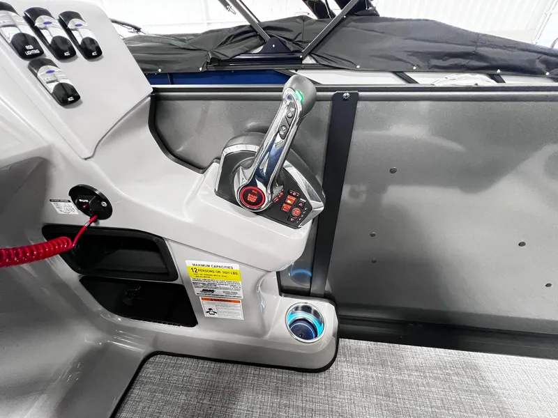 Slide: The Image of 2024 Harris Sunliner 230 boat control panel with throttle and switches. - 25