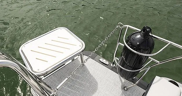 Slide: The Image of 2024 Harris Sunliner 230 boat deck with safety railing and water view. - 27