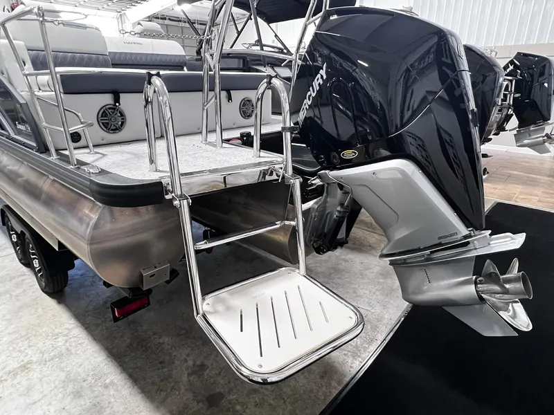 Slide: The Image of 2024 Harris Sunliner 230 boat with Mercury outboard motor and swim ladder. - 29
