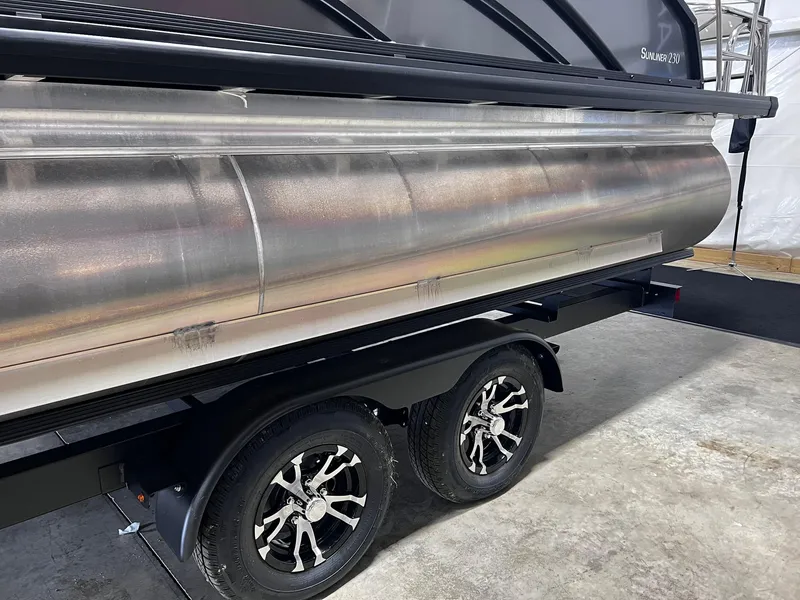 Slide: The Image of 2024 Harris Sunliner 230 pontoon boat on a dual-axle trailer. - 34