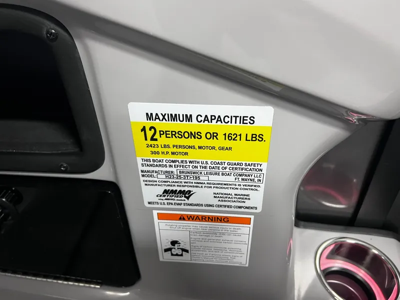 Slide: The Image of Maximum capacities label on 2024 Harris Sunliner 230 boat, indicating 12 persons or 1621 lbs. - 35