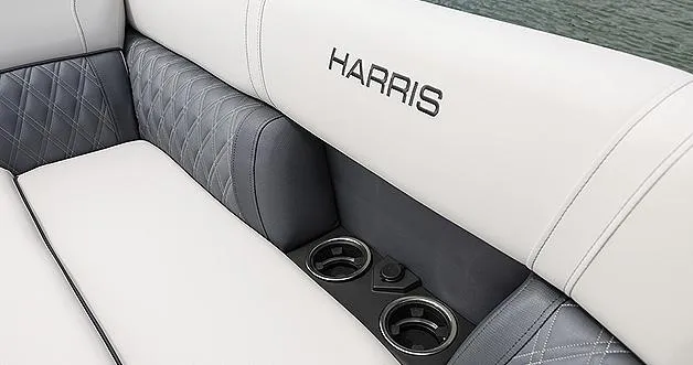 Slide: The Image of 2024 Harris Sunliner 230 boat interior with cup holders and luxurious seating. - 38