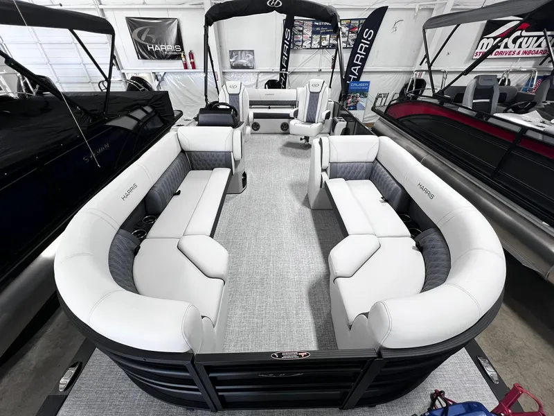 Slide: The Image of 2024 Harris Sunliner 230 pontoon boat with spacious seating and modern design. - 6