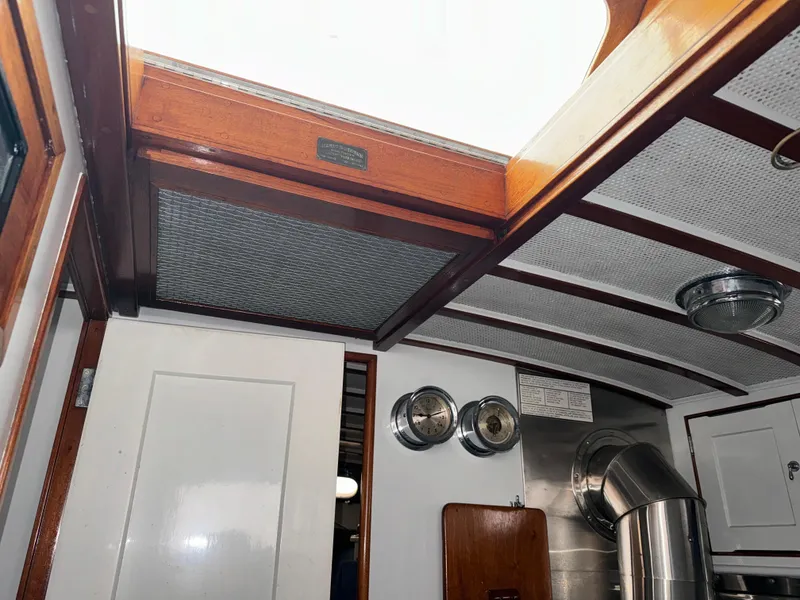 Slide: The Image of Interior of 1947 Rhodes Nevins Picnic Boat with wooden ceiling and metal fixtures. - 10