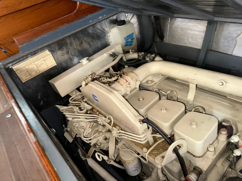 Slide: The Image of Engine compartment of a 1947 Rhodes Nevins Picnic Boat, showcasing mechanical components. - 17