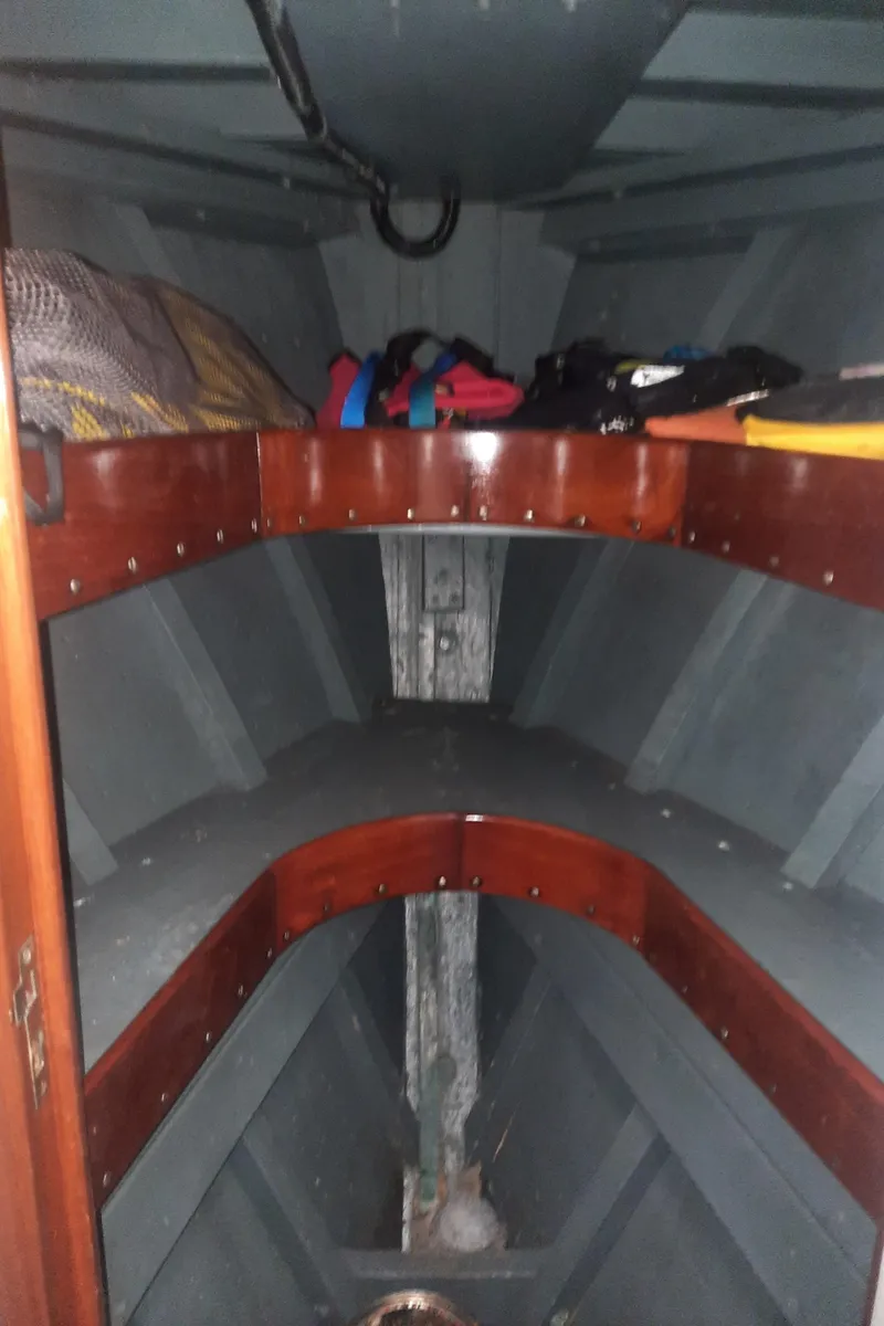 Slide: The Image of Interior of a 1947 Rhodes Nevins Picnic Boat with wooden shelves and storage. - 19