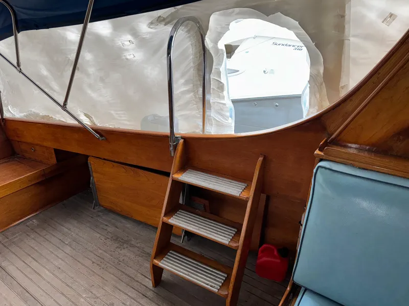 Slide: The Image of 1947 Rhodes Nevins Picnic Boat interior with wooden steps and seating. - 8