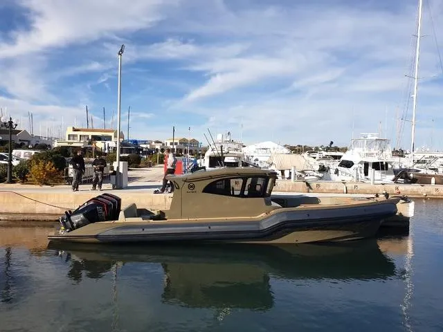 The Image of Rafnar 40 Cabin 2024 boat docked at a marina with clear skies. - 1