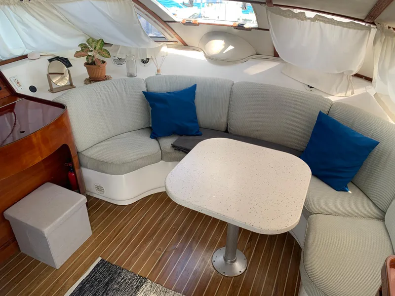 Slide: The Image of Cozy interior of 1993 Lagoon TPI 42 yacht with curved seating and table. - 26