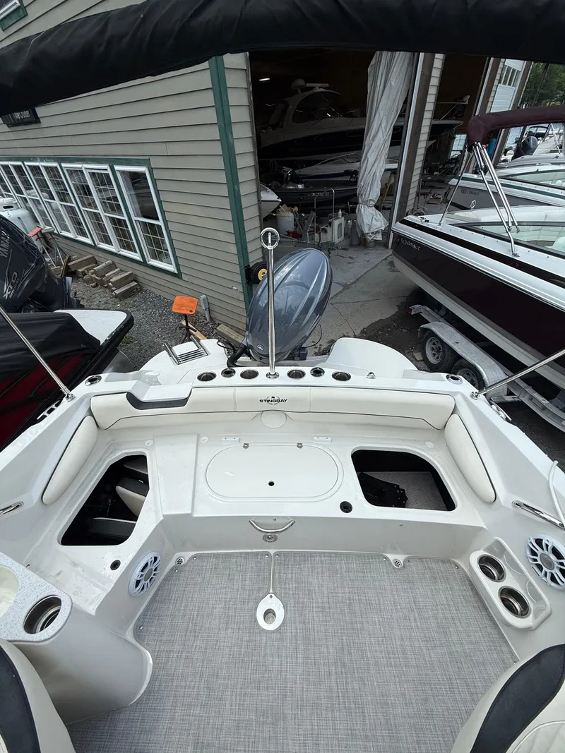 Slide: The Image of 2024 Stingray 201DC boat interior with open compartments and modern design. - 10