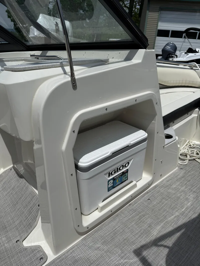 Slide: The Image of 2024 Stingray 201DC boat interior with built-in Igloo cooler storage. - 19