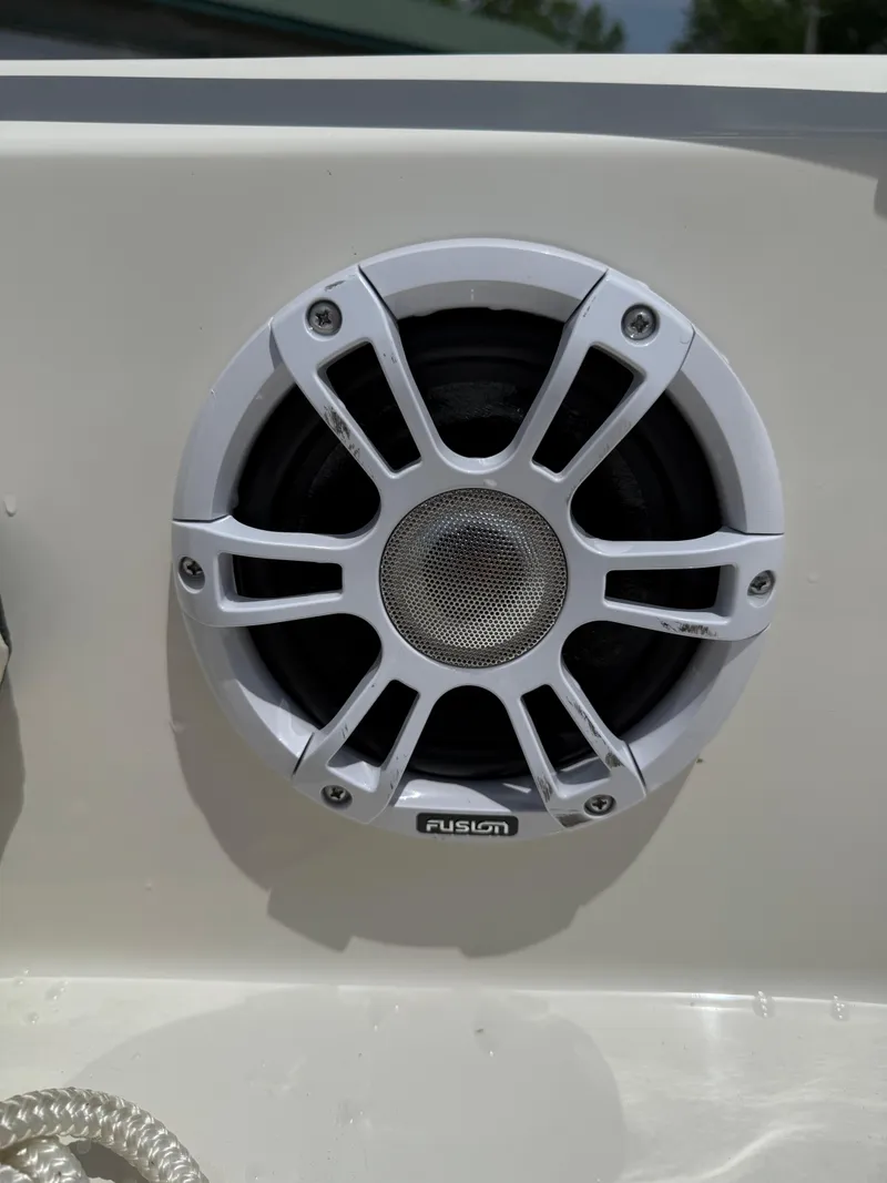 Slide: The Image of 2024 Stingray 201DC boat with Fusion marine speaker, close-up view. - 25