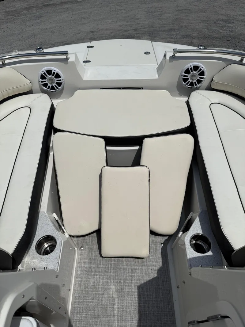 Slide: The Image of 2024 Stingray 201DC boat interior with cushioned seating and cup holders. - 26
