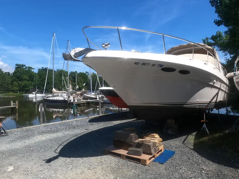 Slide: The Image of 2001 Sea Ray 340 Sundancer yacht on dry dock near marina. - 1