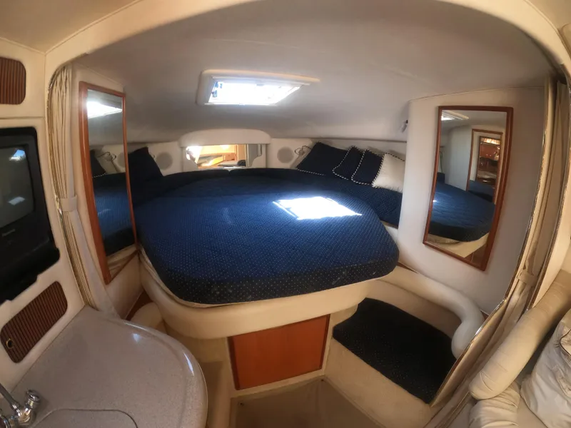 Slide: The Image of 2001 Sea Ray 340 Sundancer cabin with bed, mirrors, and skylight. - 10