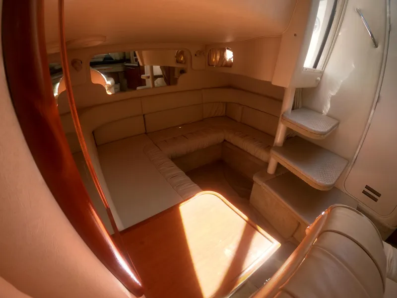 Slide: The Image of Interior of 2001 Sea Ray 340 Sundancer with beige seating and wooden accents. - 12
