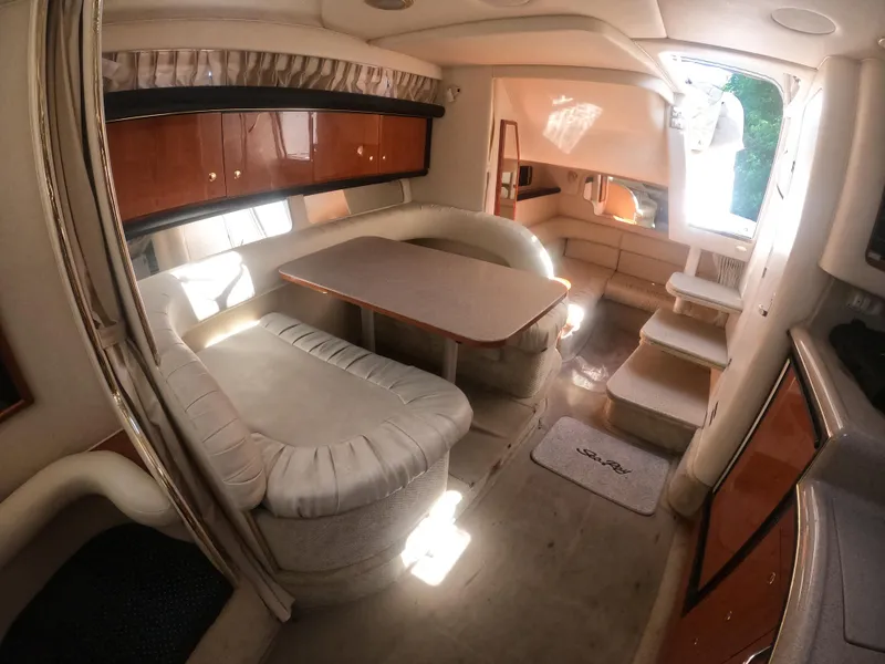 Slide: The Image of Interior of 2001 Sea Ray 340 Sundancer yacht with dining area and steps to cabin. - 13