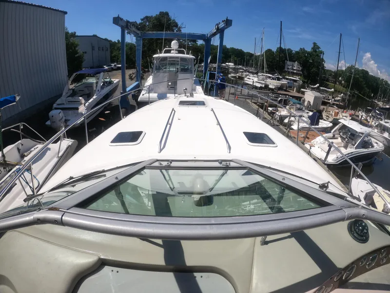 Slide: The Image of 2001 Sea Ray 340 Sundancer yacht docked at a marina. - 3