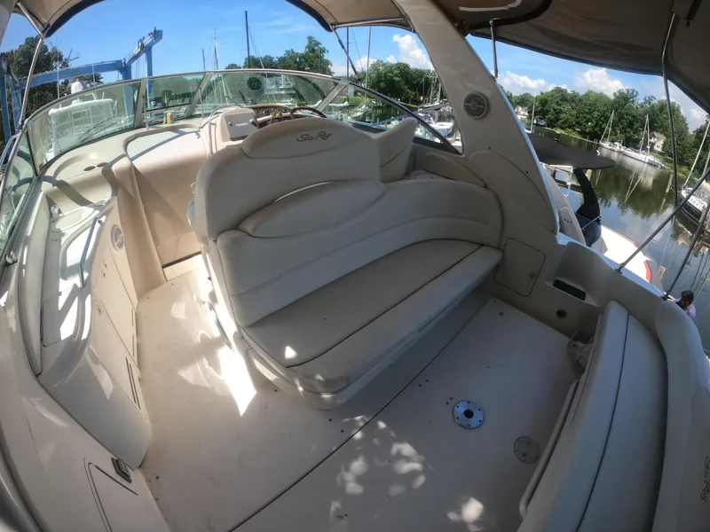 Slide: The Image of 2001 Sea Ray 340 Sundancer boat interior with white seating and helm. - 6