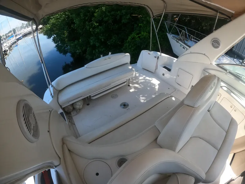 Slide: The Image of 2001 Sea Ray 340 Sundancer boat interior with white leather seating and canopy. - 8
