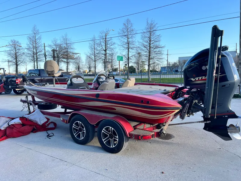 Slide: The Image of 2004 Stratos 201 Pro XL boat on trailer, red with dual motors, parked outdoors. - 6