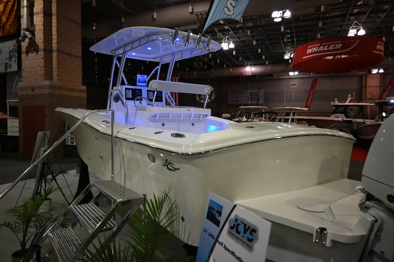Slide: The Image of 2025 Jersey Cape 31 Little Devil boat displayed at an indoor boat show. - 3