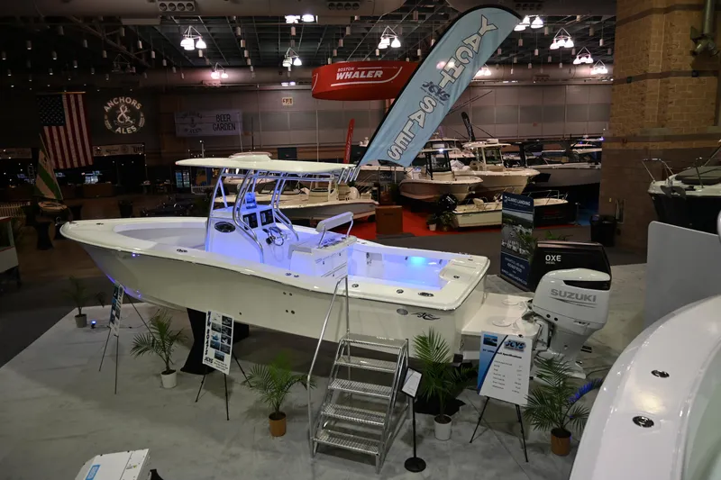 Slide: The Image of 2025 Jersey Cape 31 Little Devil boat on display at an indoor boat show. - 4