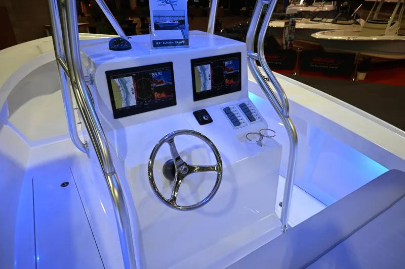 Slide: The Image of 2025 Jersey Cape 31 Little Devil boat console with dual displays and steering wheel. - 5