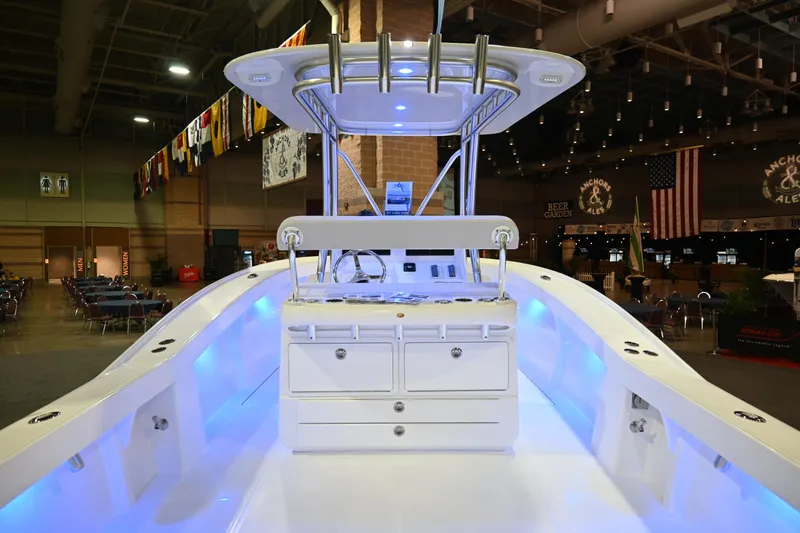 Slide: The Image of 2025 Jersey Cape 31 Little Devil boat interior with illuminated console and storage drawers. - 6
