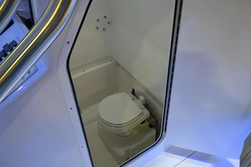Slide: The Image of 2025 Jersey Cape 31 Little Devil boat interior with compact marine toilet. - 16