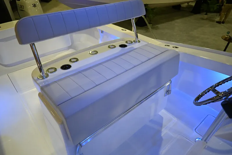 Slide: The Image of 2025 Jersey Cape 31 Little Devil boat interior with cushioned seating and rod holders. - 17