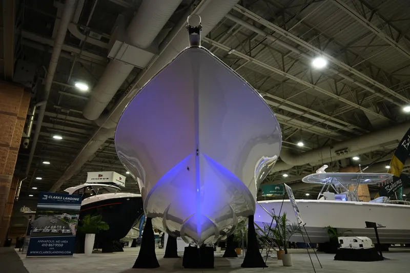 Slide: The Image of 2025 Jersey Cape 31 Little Devil boat displayed at an indoor boat show. - 2