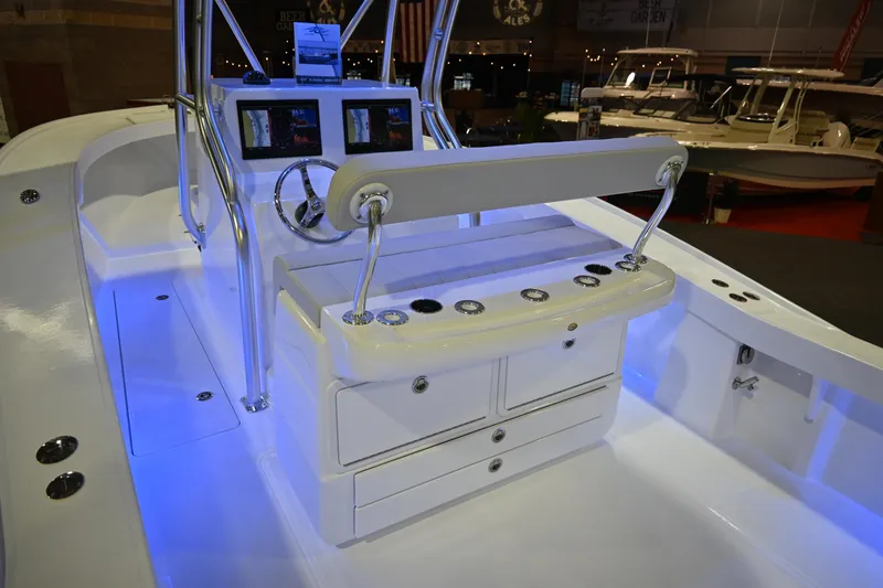Slide: The Image of 2025 Jersey Cape 31 Little Devil boat interior with illuminated console and storage drawers. - 7