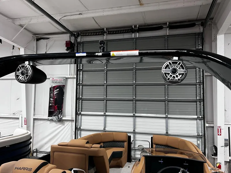 Slide: The Image of 2024 Harris 250 Grand Mariner V10 400 interior with speakers and seating in a showroom. - 12