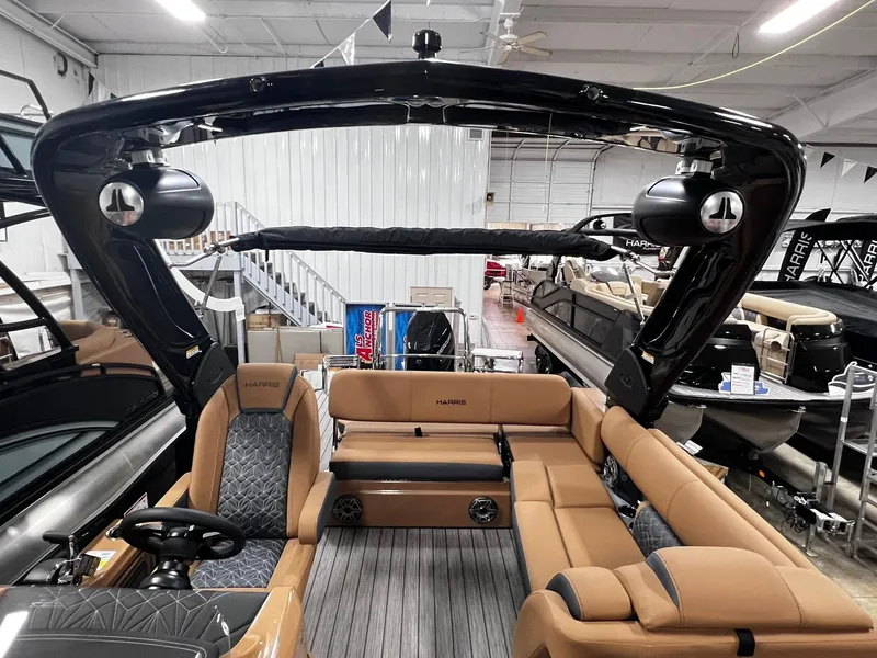 Slide: The Image of 2024 Harris 250 Grand Mariner V10 400 pontoon boat with luxurious seating and sleek design. - 2