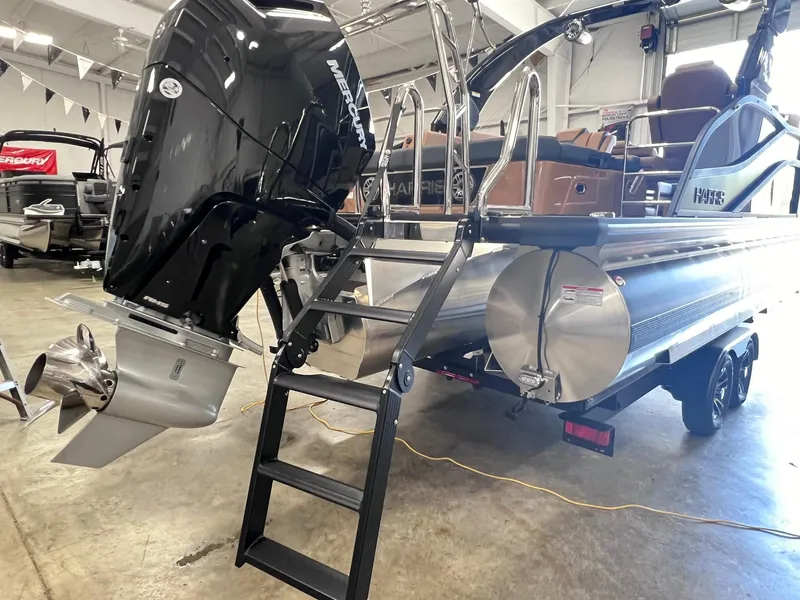 Slide: The Image of 2024 Harris 250 Grand Mariner V10 400 boat with Mercury outboard engine in showroom. - 25