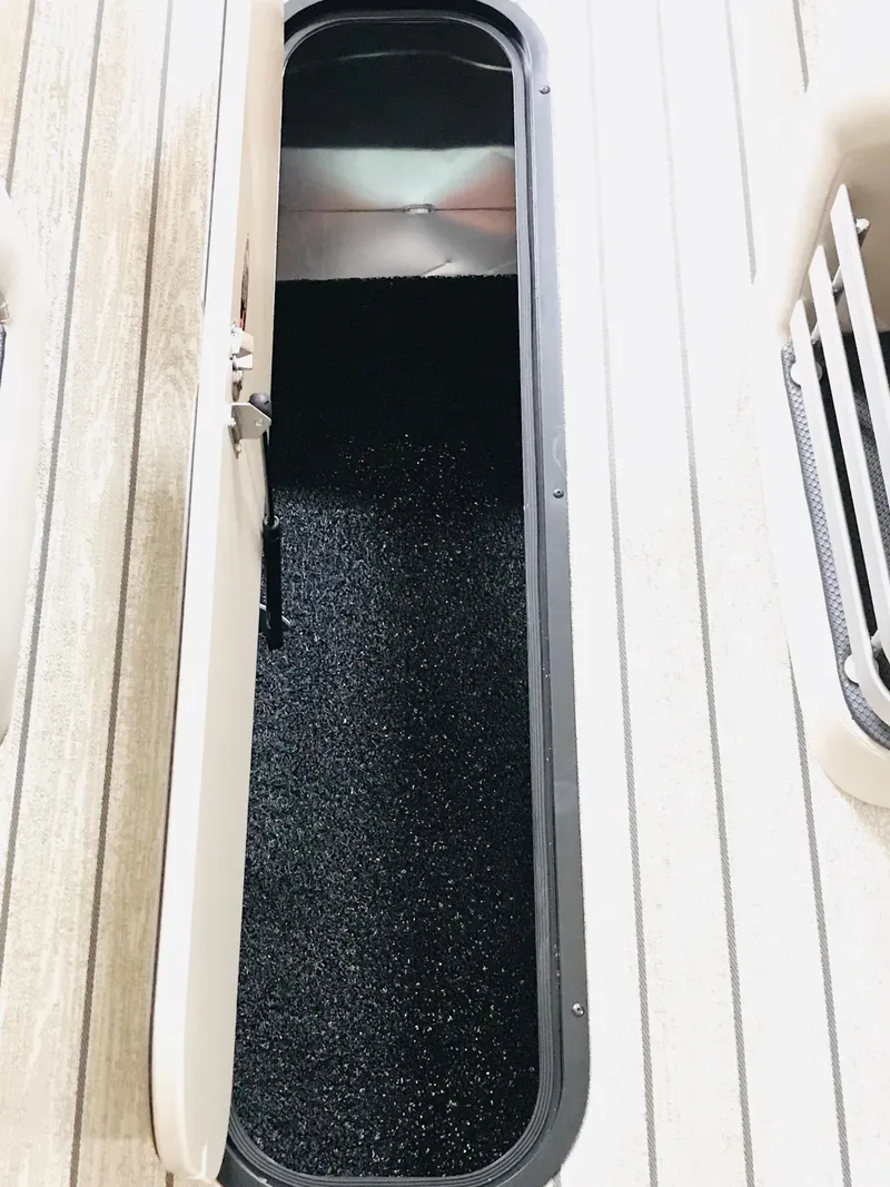 Slide: The Image of Luxurious seating on 2024 Harris 250 Grand Mariner V10 400 boat, featuring tan and gray upholstery. - 31