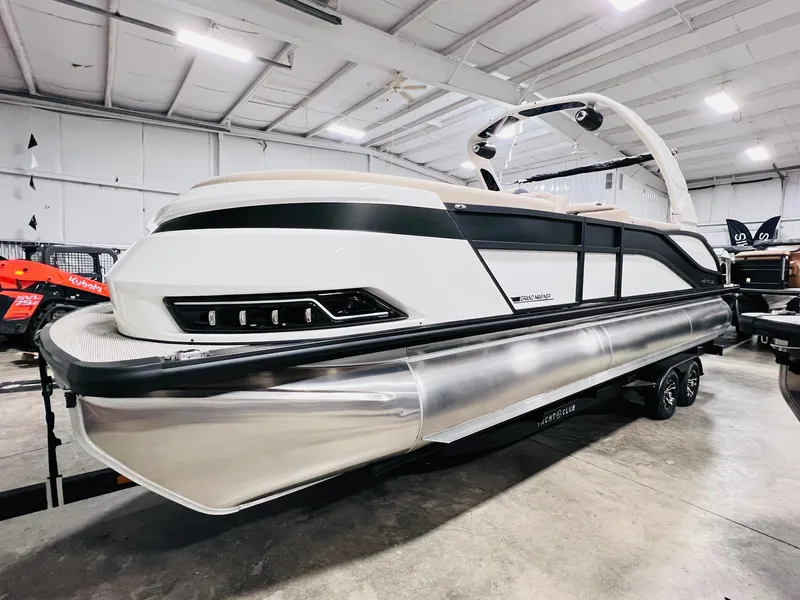 Slide: The Image of 2024 Harris 250 Grand Mariner V10 400 pontoon boat in showroom. - 2