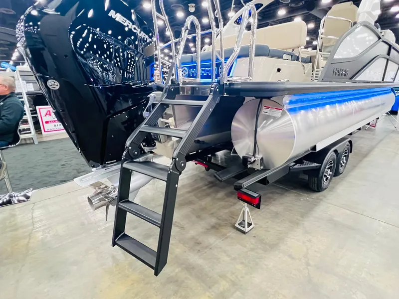 Slide: The Image of 2024 Harris FloteBote 250 Grand Mariner V10 400 pontoon boat with blue LED lights at night. - 30