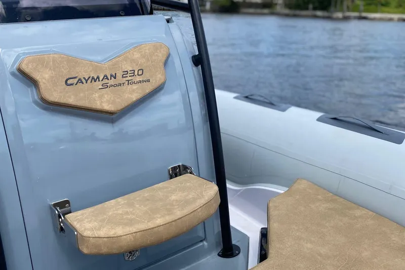 Slide: The Image of 2025 Ranieri Cayman 23.0 Sport Touring boat interior by the water. - 13