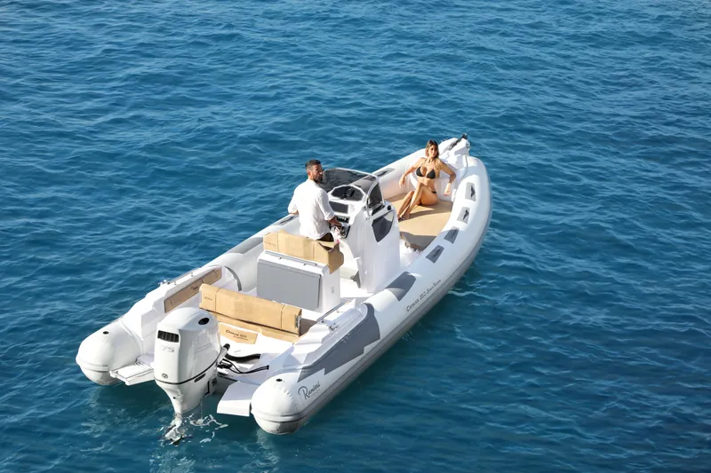 Slide: The Image of 2025 Ranieri Cayman 23.0 Sport Touring boat on clear blue water. - 15