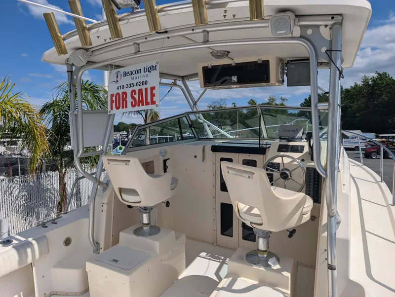 Slide: The Image of 1999 Parker 2510 Walkaround boat for sale, dual seats, steering wheel, and control panel. - 11