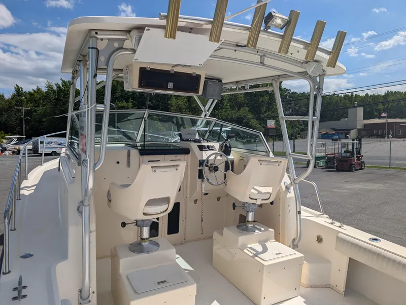 Slide: The Image of 1999 Parker 2510 Walkaround boat cockpit with dual seats and steering wheel. - 12