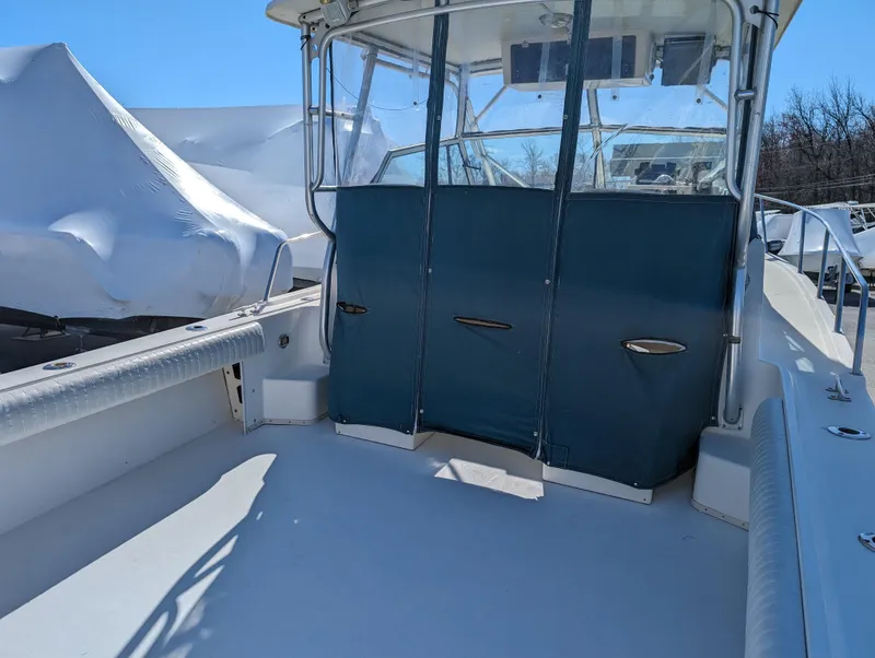 Slide: The Image of 1999 Parker 2510 Walkaround boat deck with covered cockpit area. - 18