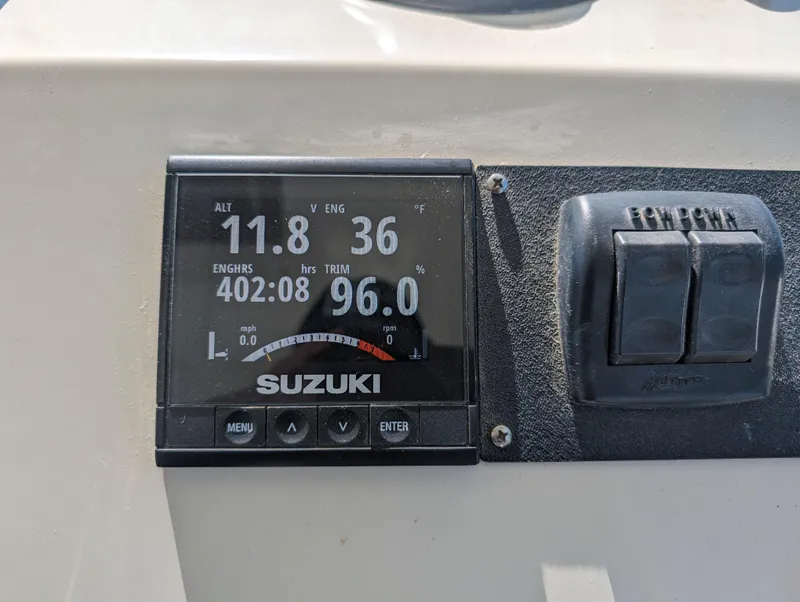 Slide: The Image of Suzuki engine display on a 1999 Parker 2510 Walkaround boat dashboard. - 22
