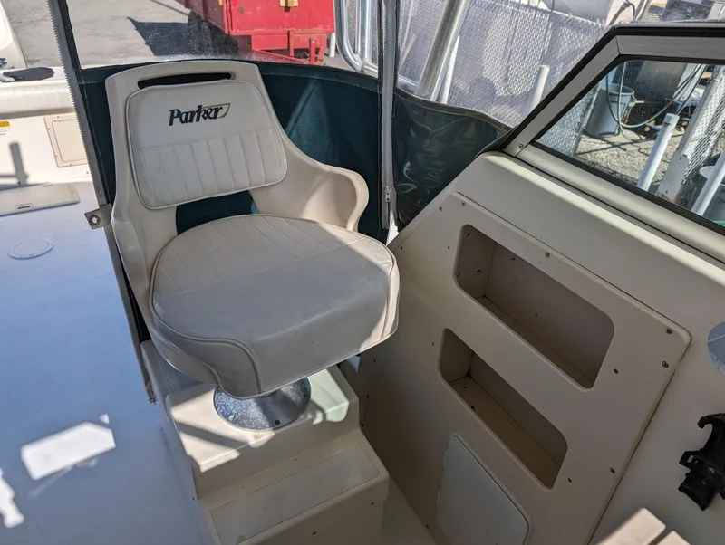 Slide: The Image of 1999 Parker 2510 Walkaround boat captain's chair and console. - 30