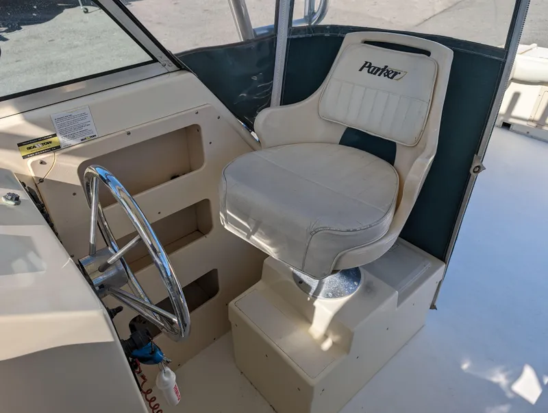 Slide: The Image of Captain's chair and helm of a 1999 Parker 2510 Walkaround boat. - 31
